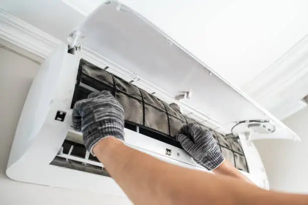 Skilled HVAC technician testing airflow and electrical readings during AC repair service
