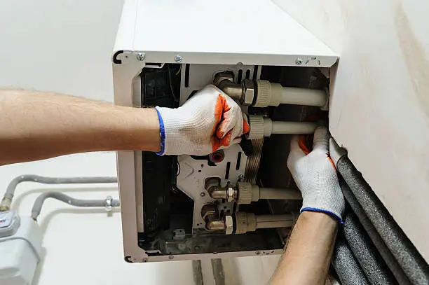 Technician diagnosing furnace problem in Marlboro home with uneven heating
