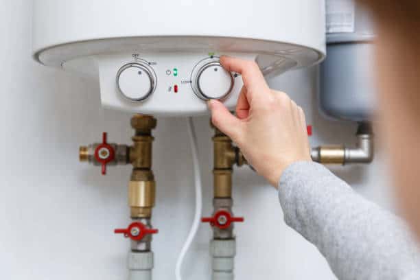 Technician repairing residential furnace in Manalapan home during winter breakdown