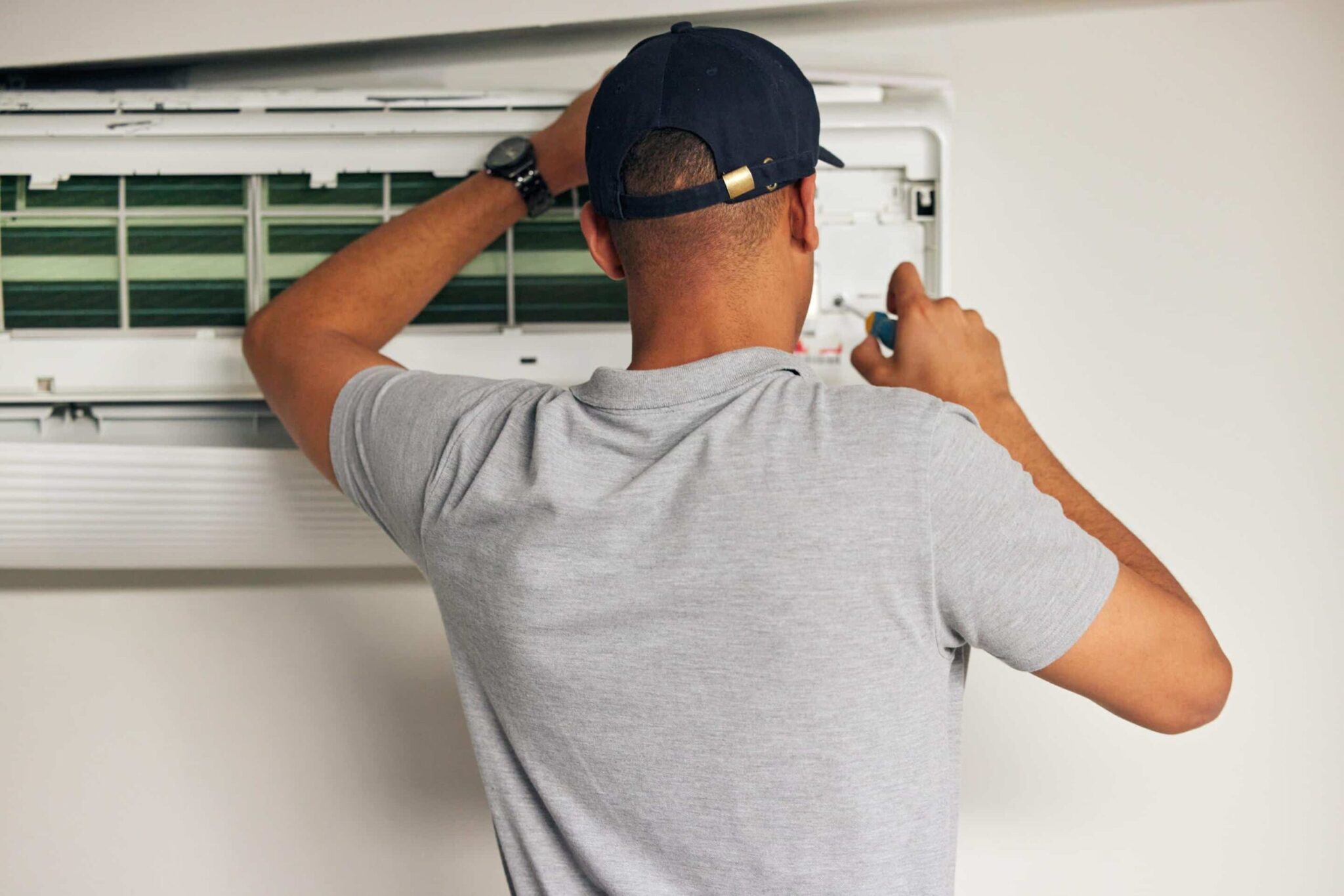 HVAC Air conditioning installation Monmouth County NJ - Jersey Heat and Air, Licensed HVAC technician diagnosing airflow and electrical issues with professional testing equipment, Experienced HVAC technician testing system performance and airflow with professional diagnostic equipment