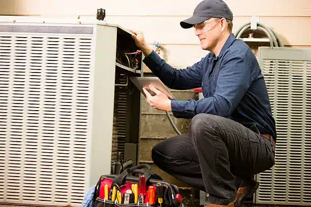 Experienced HVAC installer aligning new system components for precise home setup